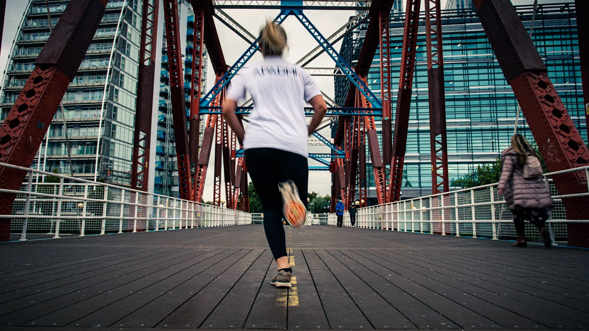 Girl running with Apadmi shirt on