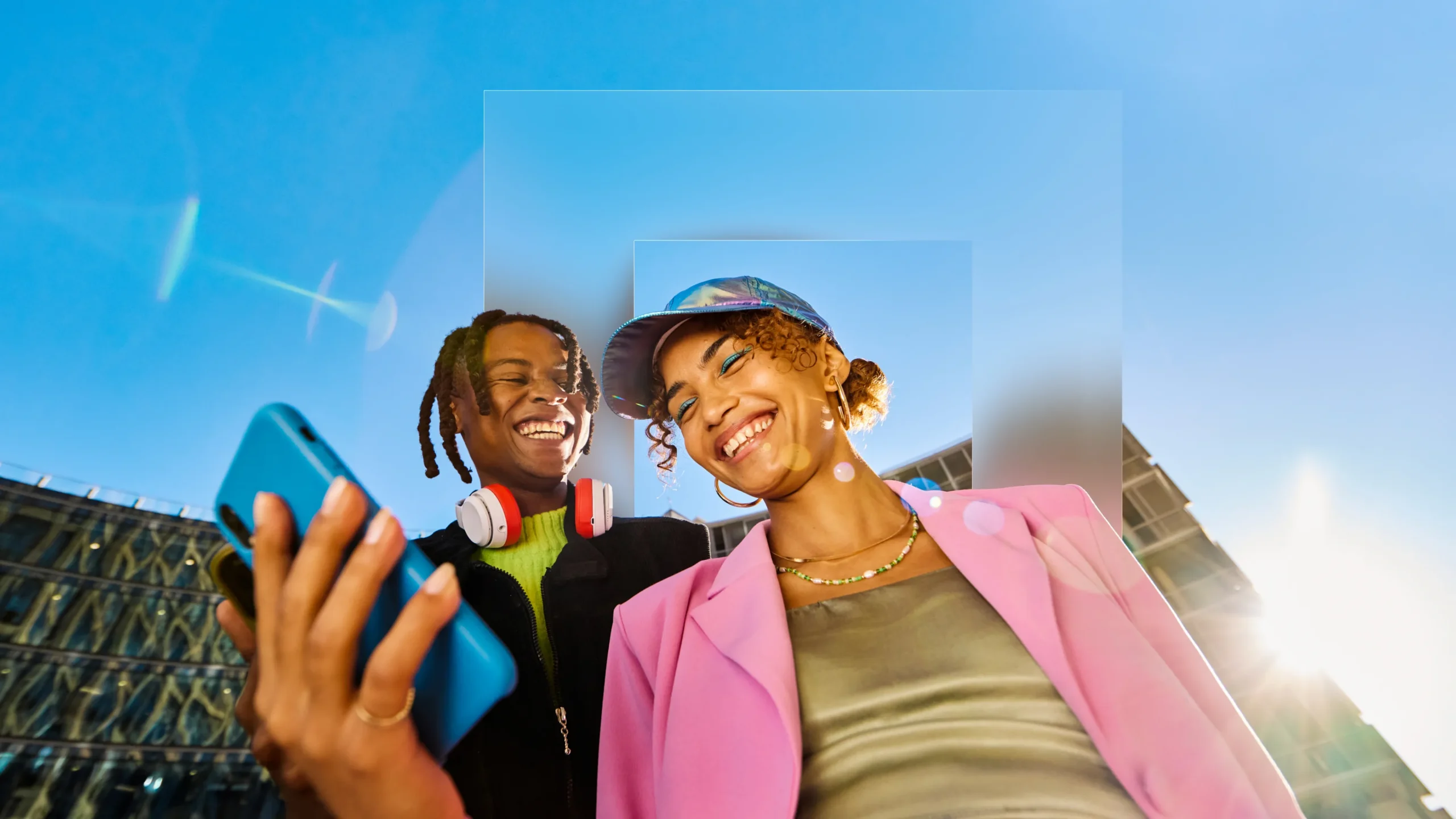 A smiling Gen Z couple look at a phone, with the Apadmi square behind them.