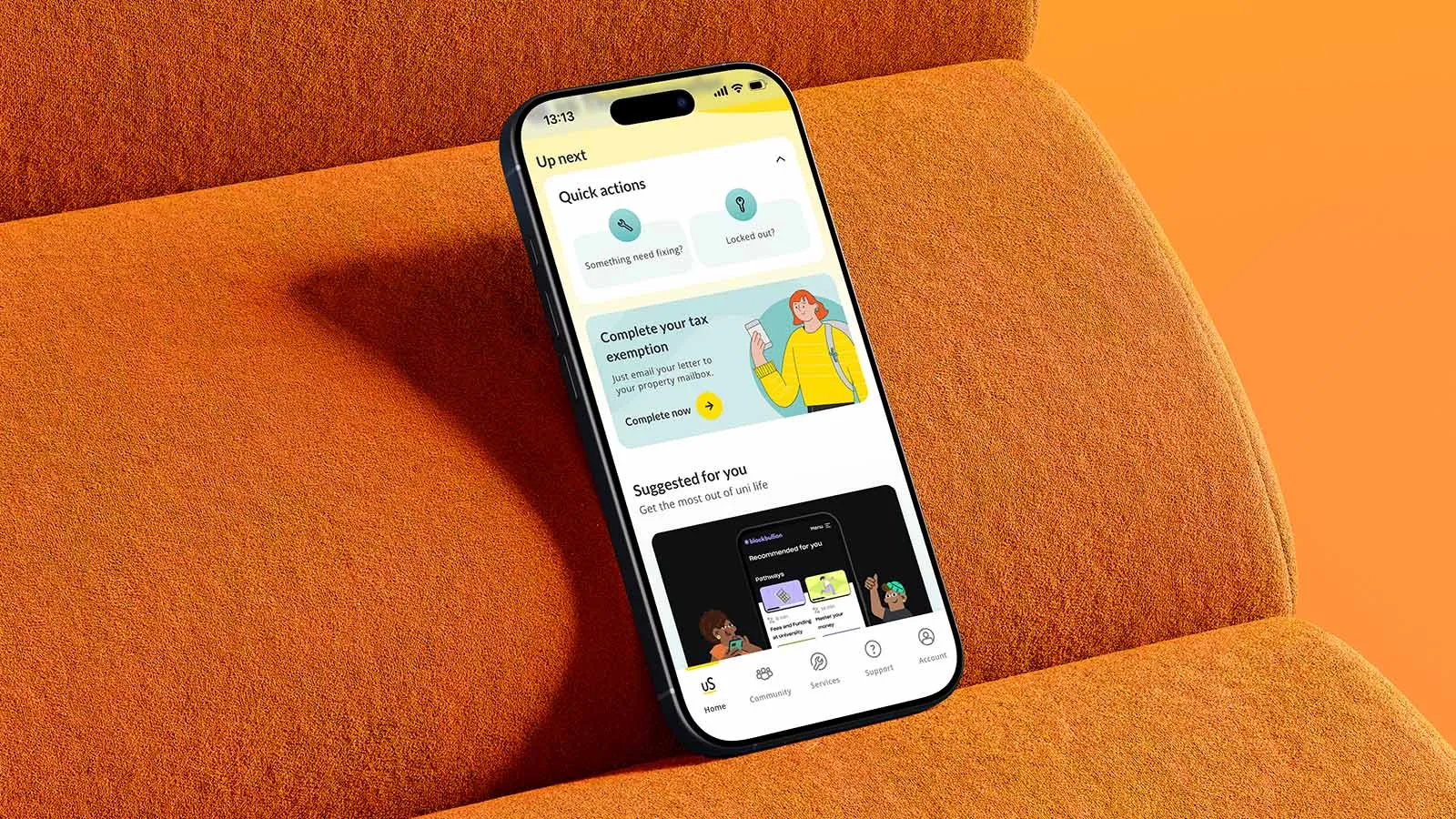 A phone displaying the Unite Students app rests on an orange chair